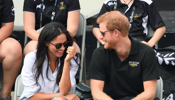 Meghan Markle makes ‘husband’ gesture as she holds hands with Prince Harry in Canada on first public appearance together in £221 designer shirt