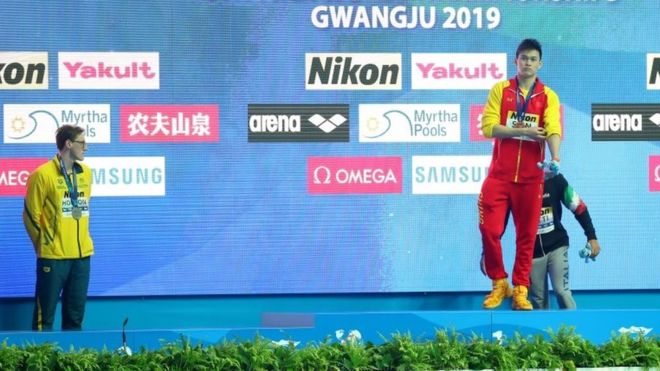 Australian swimmer refuses to join rival on podium
