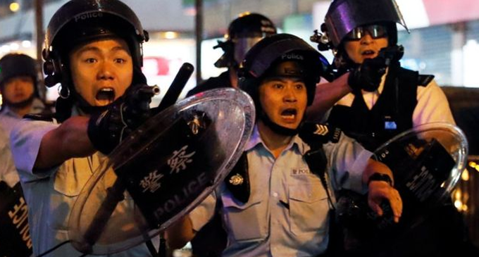 Hong Kong police fire gun and use water cannon on protesters