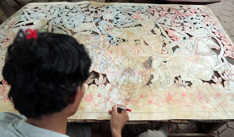 Using his imagination, a young Cambodian creates the country’s largest shadow puppet